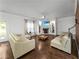 Spacious living room with hardwood floors, a fireplace, and plenty of natural light at 3945 Silverthorn Trce, Cumming, GA 30028