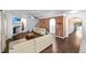 Bright living room with hardwood floors, fireplace and access to the foyer at 3945 Silverthorn Trce, Cumming, GA 30028