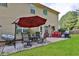 Inviting patio with seating area, umbrella, and grill at 3945 Silverthorn Trce, Cumming, GA 30028