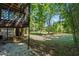 Large backyard with lush greenery and screened porch at 4090 Tara Dr, Forest Park, GA 30297