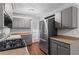Updated kitchen, stainless steel appliances, and gray cabinets at 4090 Tara Dr, Forest Park, GA 30297
