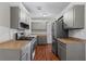 Gray cabinets, stainless steel appliances and laminate flooring at 4090 Tara Dr, Forest Park, GA 30297