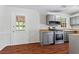 Gray kitchen cabinets, stainless steel appliances, and laminate flooring at 4090 Tara Dr, Forest Park, GA 30297
