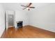 Bright bedroom with hardwood floors, fireplace, and access to another room at 6851 Roswell Rd # I29, Atlanta, GA 30328
