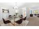 Modern dining area with glass table, chairs, and built-in shelving at 6851 Roswell Rd # I29, Atlanta, GA 30328