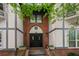 Building entrance with brick facade and landscaping at 6851 Roswell Rd # I29, Atlanta, GA 30328