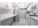 Efficient kitchen with white cabinets, new appliances, and tile floor at 6851 Roswell Rd # I29, Atlanta, GA 30328