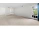 Open living area with neutral decor and access to balcony at 6851 Roswell Rd # I29, Atlanta, GA 30328