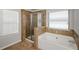 Bathroom features a shower and garden tub at 5345 Bucknell Trce, Cumming, GA 30028