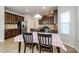 Eat-in kitchen with dark wood cabinets and granite countertops at 5345 Bucknell Trce, Cumming, GA 30028