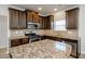 Kitchen features granite countertops and dark wood cabinets at 5345 Bucknell Trce, Cumming, GA 30028