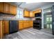 Kitchen with wood cabinets, modern appliances, and vinyl flooring at 99 Moreland Se Ave, Atlanta, GA 30316