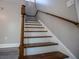 Wooden staircase with white risers and wooden railing at 99 Moreland Se Ave, Atlanta, GA 30316