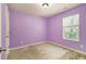 Purple painted bedroom with window and closet at 2137 Chadwick Road, Atlanta, GA 30331