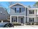 Two-story townhome with gray siding, black shutters, and a small front yard at 2137 Chadwick Road, Atlanta, GA 30331
