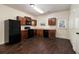 Kitchen with dark wood cabinets, black appliances, and dark flooring at 2137 Chadwick Road, Atlanta, GA 30331