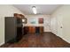 Galley kitchen, dark wood cabinets, black appliances and door to backyard at 2137 Chadwick Road, Atlanta, GA 30331