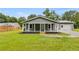 Gray house with a front porch and detached garage at 233 Rainey Rd, Temple, GA 30179