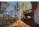 Sloped backyard with a deck and surrounding trees at 622 Royal Crest Ct, Canton, GA 30115