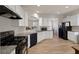 Modern kitchen with white cabinets, granite countertops, and black appliances at 622 Royal Crest Ct, Canton, GA 30115