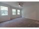 Bright bedroom with ceiling fan and large windows, carpeted at 712 Dodd Ln # 154, Buford, GA 30518