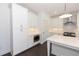 Modern white kitchen with island, stainless steel appliances, and dark hardwood floors at 712 Dodd Ln # 154, Buford, GA 30518