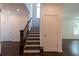 Elegant staircase with dark wood railings and steps at 712 Dodd Ln # 154, Buford, GA 30518