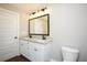 Bathroom boasting a double vanity with granite countertop and white cabinets at 488 West Ave, Bowdon, GA 30108