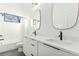 Modern bathroom with double vanity, quartz countertop, and matte black fixtures at 1099 Hawthorne Ne St, Atlanta, GA 30307