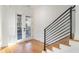 Light and airy entryway with hardwood floors and modern staircase at 1099 Hawthorne Ne St, Atlanta, GA 30307