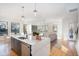 Open concept kitchen with island, stainless steel appliances, and hardwood floors at 1099 Hawthorne Ne St, Atlanta, GA 30307