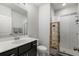 Clean bathroom with a walk-in shower, white tile, and dark vanity at 1187 Rambler Cross, Atlanta, GA 30312