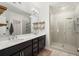 Modern bathroom with double vanity, glass shower, and floating shelves at 1187 Rambler Cross, Atlanta, GA 30312