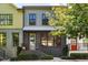 Modern townhouses with gray, green, and yellow siding, featuring black metal railings and landscaping at 1187 Rambler Cross, Atlanta, GA 30312