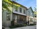 Modern townhouses with gray, green, and yellow siding, featuring black metal railings and landscaping at 1187 Rambler Cross, Atlanta, GA 30312