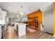 Modern kitchen with white cabinets, a large island, and an accent wall at 1187 Rambler Cross, Atlanta, GA 30312