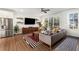 Living room with hardwood floors, gray couch, and large TV at 1187 Rambler Cross, Atlanta, GA 30312