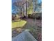 Backyard with grassy area and trees at 1779 Big Horn Se Ct, Conyers, GA 30013