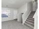 Spacious living room with grey carpet and staircase at 2089 Glenwood Downs Dr, Decatur, GA 30035