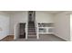 Living room with grey carpet and staircase to upper level at 2089 Glenwood Downs Dr, Decatur, GA 30035