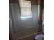 Bathroom with a bathtub and single window at 214 Pinewood Ln, Stockbridge, GA 30281