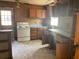 Wood cabinets and white appliances in this fixer-upper kitchen at 214 Pinewood Ln, Stockbridge, GA 30281