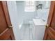 Updated bathroom with white vanity, bathtub and tile flooring at 2580 County Line Sw Rd, Atlanta, GA 30331