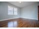 Well-lit bedroom with hardwood floors and window at 2580 County Line Sw Rd, Atlanta, GA 30331