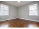 Spacious bedroom with hardwood floors, neutral walls and two windows at 2580 County Line Sw Rd, Atlanta, GA 30331