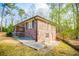 Side view of brick house with wooden deck and landscaping at 2580 County Line Sw Rd, Atlanta, GA 30331