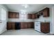 Renovated kitchen, granite countertops, dark wood cabinets, and white appliances at 2580 County Line Sw Rd, Atlanta, GA 30331