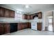 Bright kitchen with granite countertops, dark wood cabinets, and white appliances at 2580 County Line Sw Rd, Atlanta, GA 30331