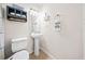 Cozy half bathroom with a pedestal sink and a toilet at 6389 Grafton Dr, Austell, GA 30168