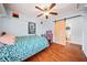 This bedroom features a ceiling fan, wood floors, and a unique sliding barn door to the bathroom at 6389 Grafton Dr, Austell, GA 30168